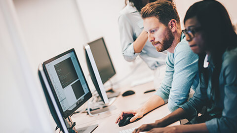 A group of programmers testing a program on a desktop computer platform