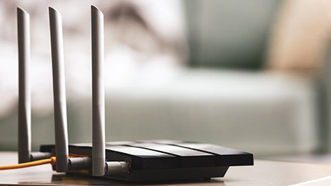 A router/modem sitting on a table