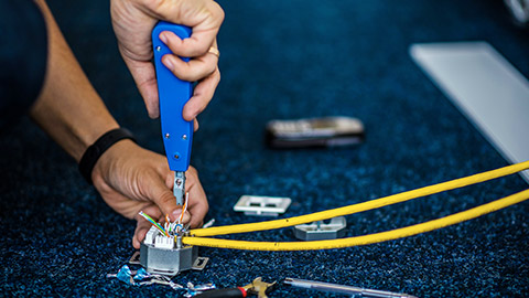 A person using a push down tool on wiring