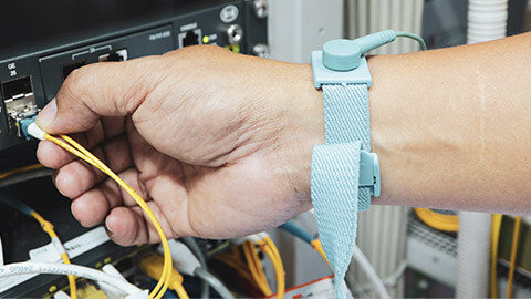 A technician wearing a static safety wristband