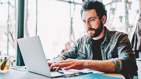 An IT manager checking user accounts on a laptop