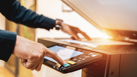 A person using a printer in an office environment