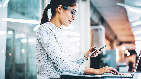 An employee checking that data from a phone is being backed up correctly