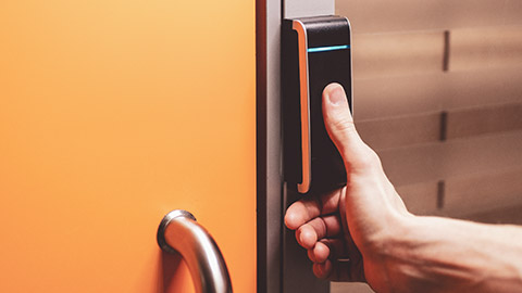 A person using a fingerprint activated door lock