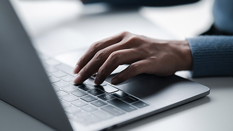 man using laptop computer placed on a table