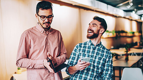 2 colleagues sharing a joke in an office environment