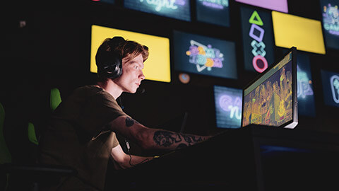 A gamer in a dark room concentrating on a match