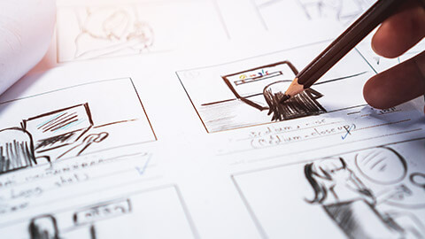 A closr view of a designer storyboarding for a game