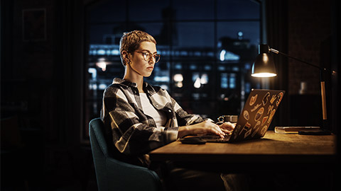 A programmer using a laptop Computer in a stylish office workspace