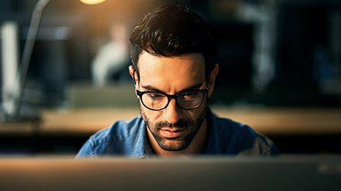 A developer working on a project in a dimly lit room