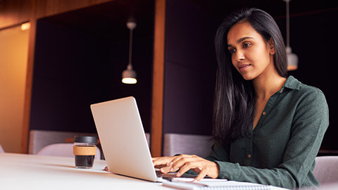 A developer using QML software on a laptop