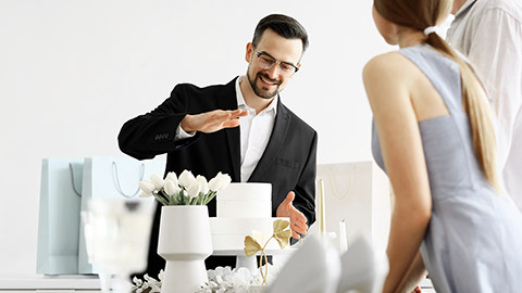 Male wedding planner working with couple