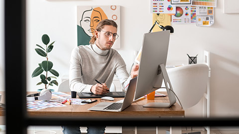 A designer working on a desktop computer