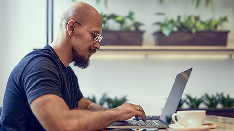 A hipster working on a laptop