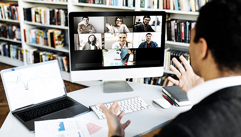 A person presenting through a laptop wo a group of people