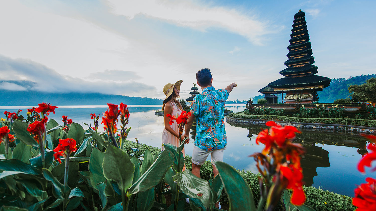 Couple spending time at the ulun datu bratan temple in Bali. Concept about exotic lifestyle wanderlust traveling