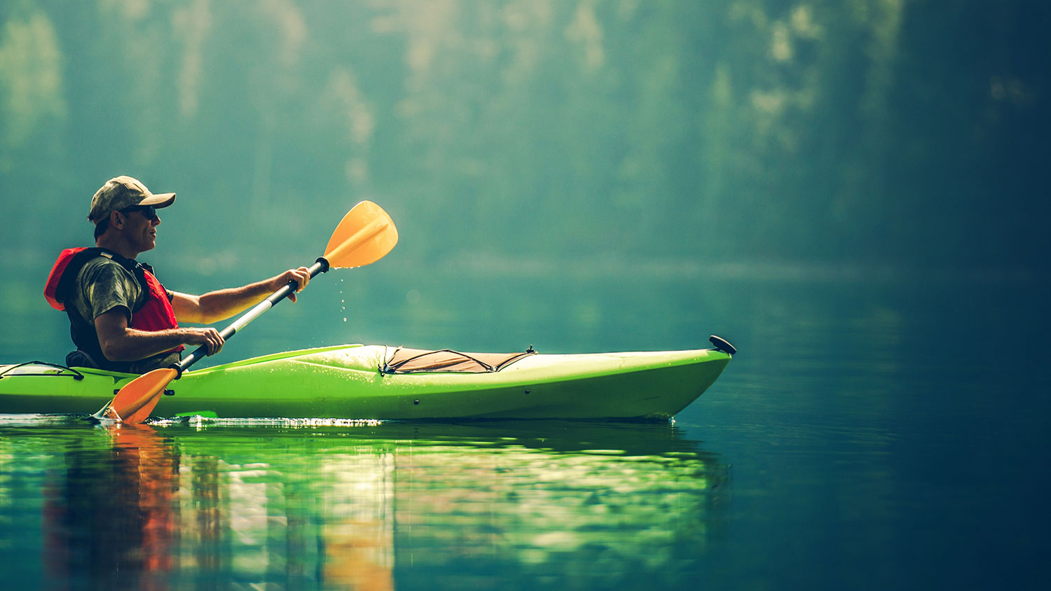 Senior Kayaker on the Lake. Kayak Paddling. Water Sport and Recreation.