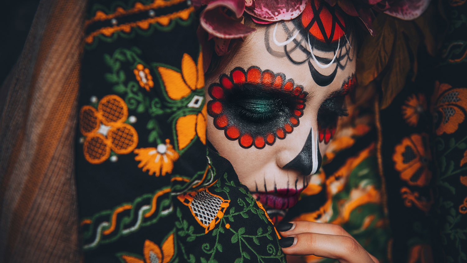 Closeup portrait of Calavera Catrina. Young woman with sugar skull makeup. Dia de los muertos. Day of The Dead. Halloween.