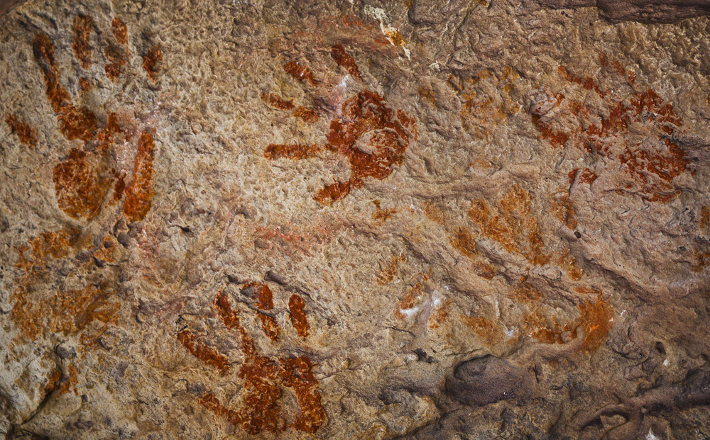 Ochre Hands, Red, Orange, Yellow hand prints on rock, Aboriginal art in Queensland