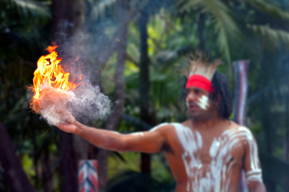 Aboriginal Australian adult man showing fire making craft on Aboriginal culture show in the tropical far north of Queensland, Australia.