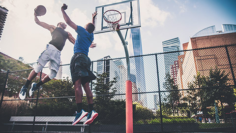 basketballers playing on outdoor court