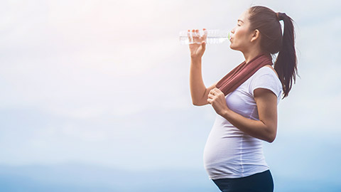 Pregnant woman drinking water