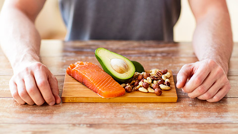 man standing in front of board with small portion of food