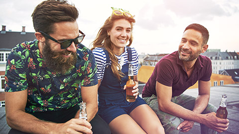 Group of friends drinking alcohol on rooftop