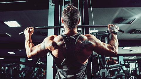 Rear view of male doing lat pulldown exercise