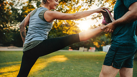 Male trainer helping female client