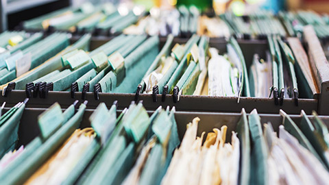 Open filing cabinet draws with lots of files visible