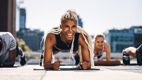 Low angle image of smiling trainer leading group session