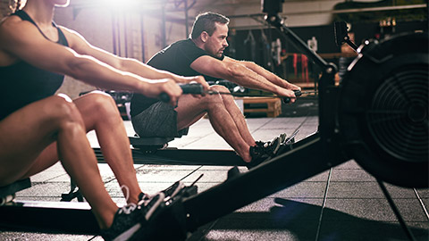 man using rowing machine