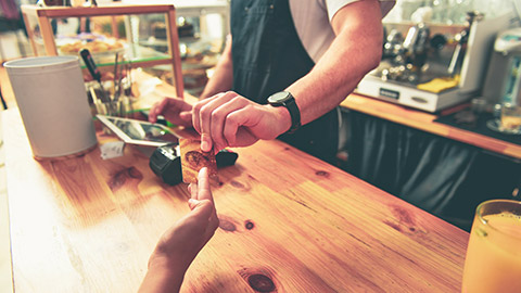 person paying cashier for purchase