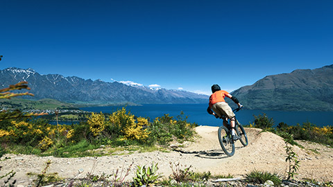 mountain biker in terrain around queenstown