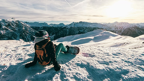 snowboarder taking in the mountain views