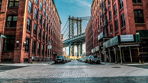 brooklyn bridge visible between buildings