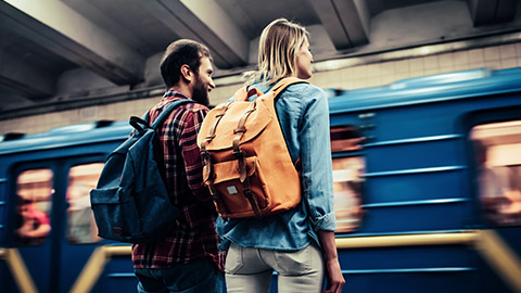 two young travellers waiting for a train