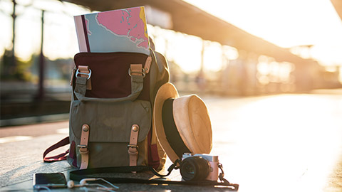 backpack with map sticking out the top