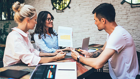 Colleagues discussing a shareholder's equity report on their organisation