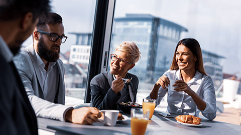 Group of business people networking at a breakfast event