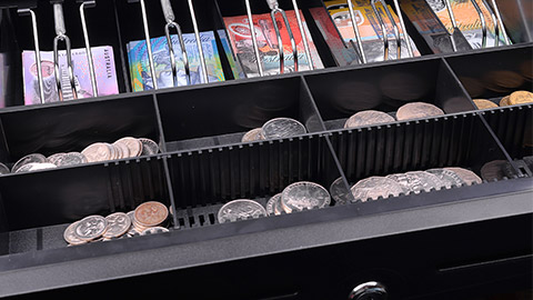 A lockable metallic drawer at the register