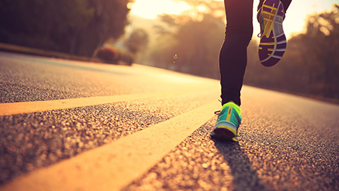 woman running along road