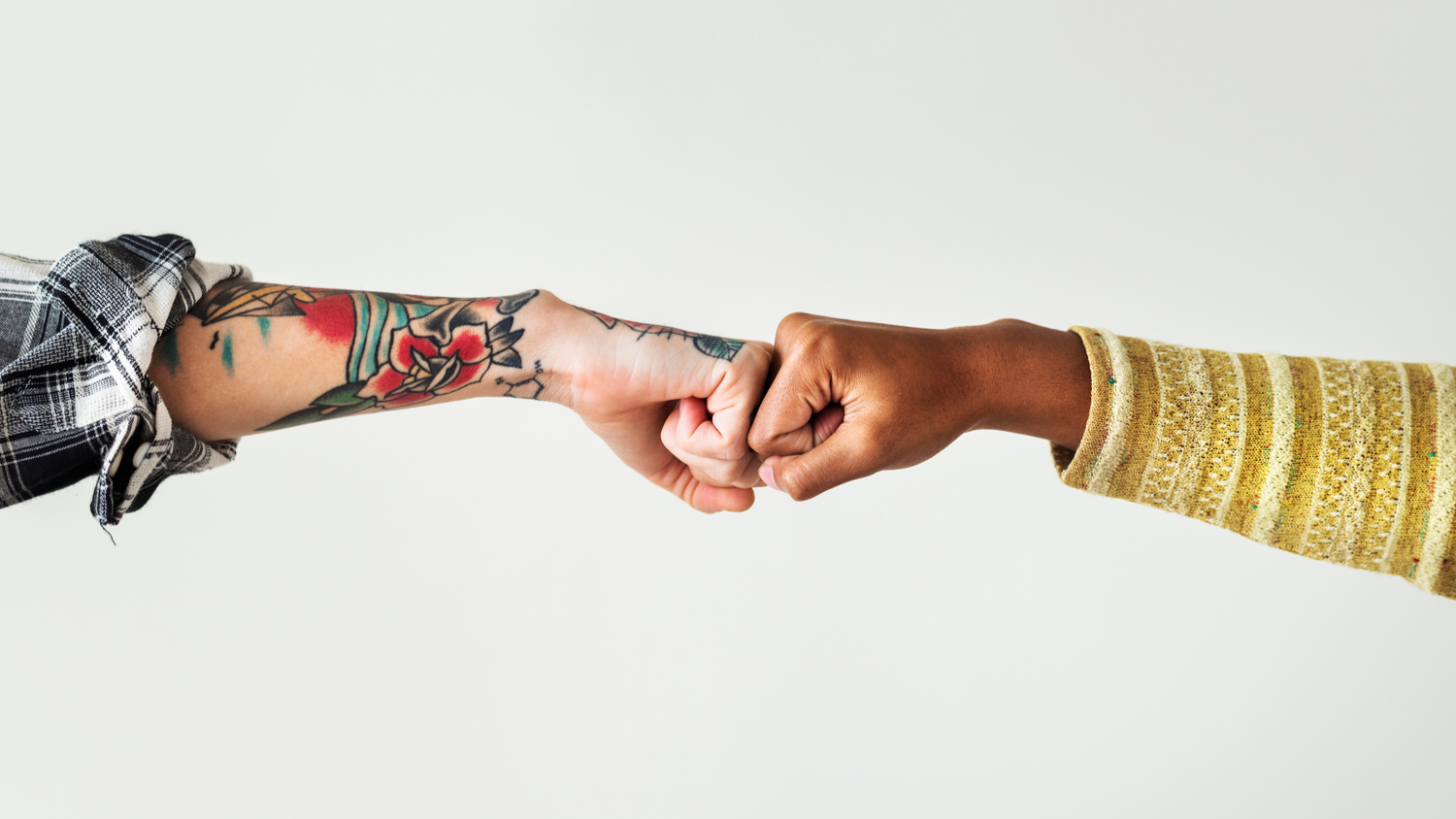 Manager and employee bumping their fists together