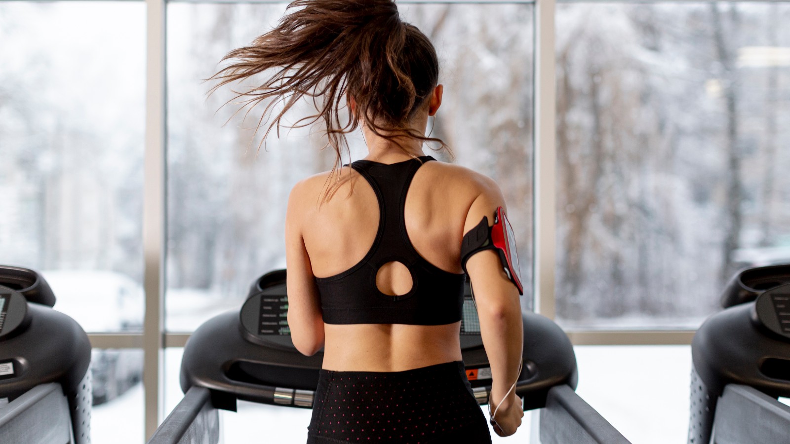 Woman running on a treadmill during a fitness session