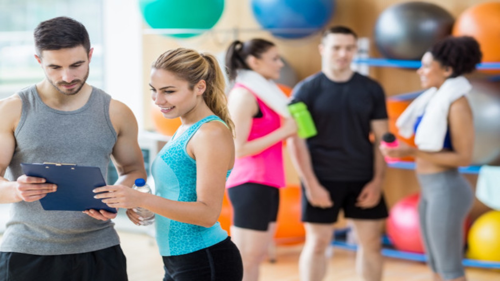 Client and trainer looking at a clipboard