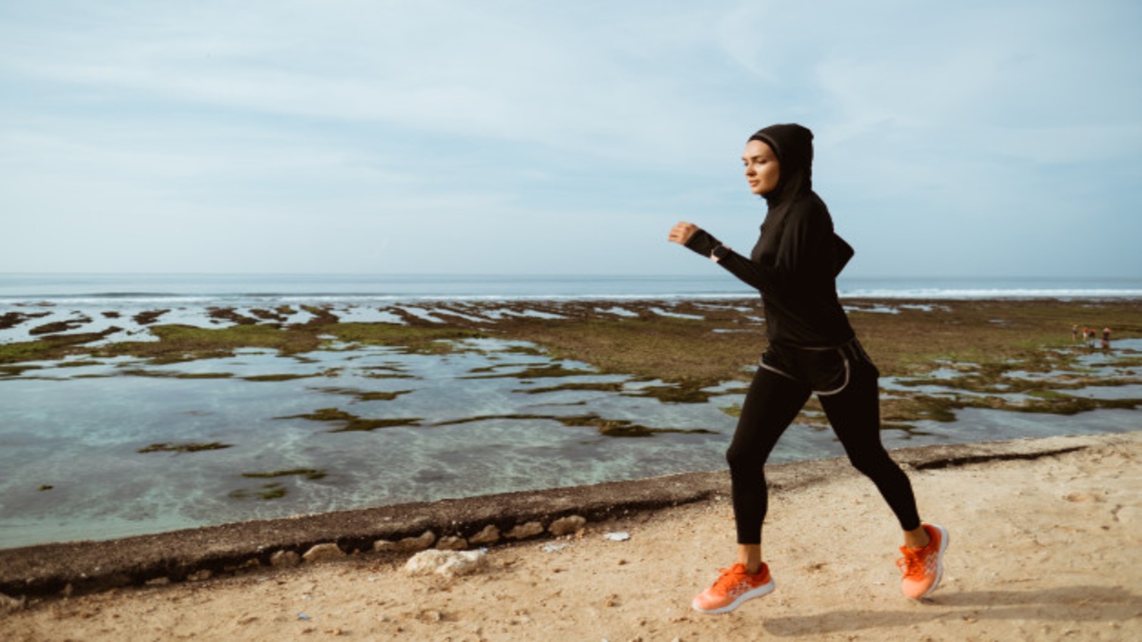 female runner wearing full body covering active wear.