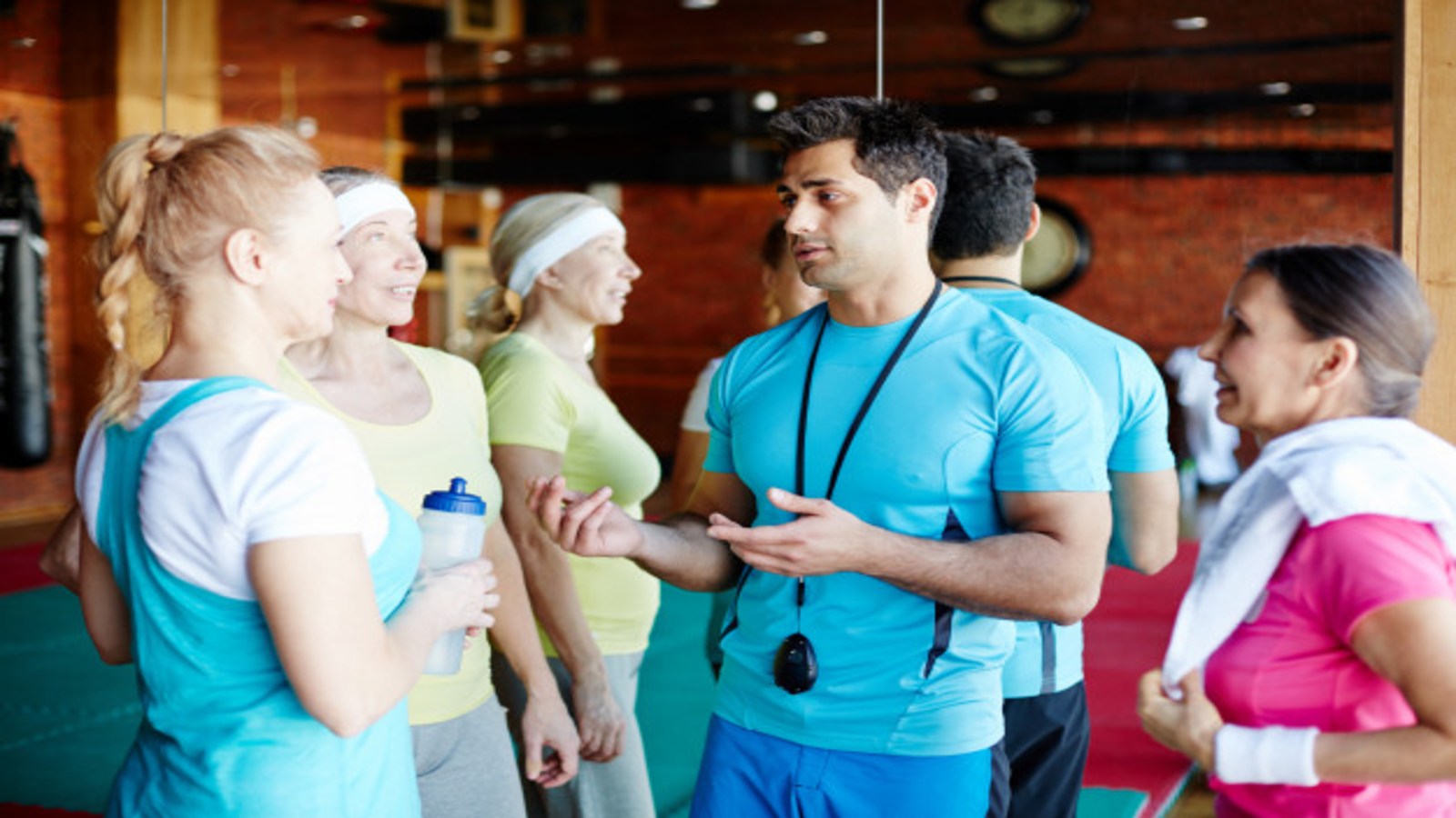 Instructor talking to three trainees.