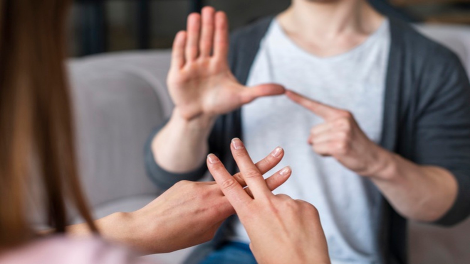 Two people using sign language.