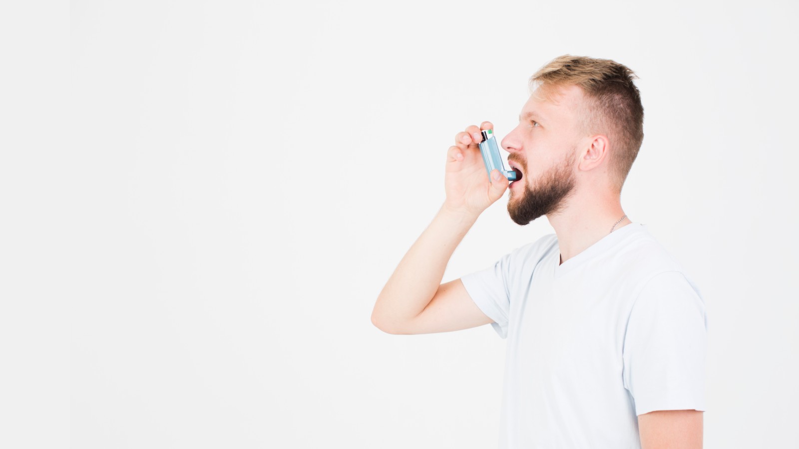 Man using an asthma enhaler